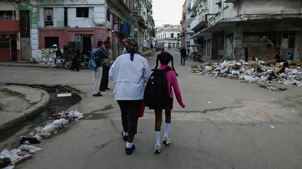 Silvia-Rosell-walks-her-granddaughter-to-school-for-a-half-day-schedule-as-the-government-adopts-measures-to-save-fuel-amid-a-deepening-shortage-affecting-the-island-Havana-Cuba-February-12-2026