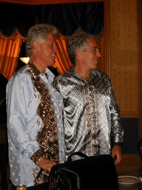 Former-U-S-President-Bill-Clinton-stands-with-Jeffrey-Epstein-in-this-image-released-by-the-Department-of-Justice-in-Washington-D-C-U-S-on-December-19-2025-as-part-of-a-new-trove-of-documents-from-its-investigations-into-the-late-financier-and-convicted-sex-offender-Jeffrey-Epstein-U-S-Justice-Department-Handout-via-REUTERS-THIS-IMAGE-HAS-BEEN-SUPPLIED-BY-A-THIRD-PARTY-THIS-PICTURE-WAS-PROCESSED-BY-REUTERS-TO-ENHANCE-QUALITY-AN-UNPROCESSED-VERSION-HAS-BEEN-PROVIDED-SEPARATELY
