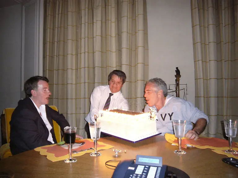 Peter-Mandelson-sits-with-late-financier-and-convicted-sex-offender-Jeffrey-Epstein-as-he-blows-out-the-candles-on-a-cake-in-an-undated-photograph-released-by-the-Department-of-Justice-in-Washington-D-C-U-S-on-December-19-2025-as-part-of-a-trove-of-documents-from-its-investigations-into-Epstein-U-S-Justice-Department-Handout-via-REUTERS-THIS-IMAGE-HAS-BEEN-SUPPLIED-BY-A-THIRD-PARTY