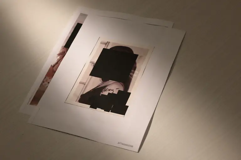 Newly-released-documents-from-disgraced-late-financier-and-sex-offender-Jeffrey-Epstein-here-including-a-redacted-photo-of-a-woman-are-seen-in-this-handout-image-released-by-the-U-S-Justice-Department-and-printed-and-arranged-for-a-photograph-by-Reuters-in-Washington-D-C-U-S-December-19-2025