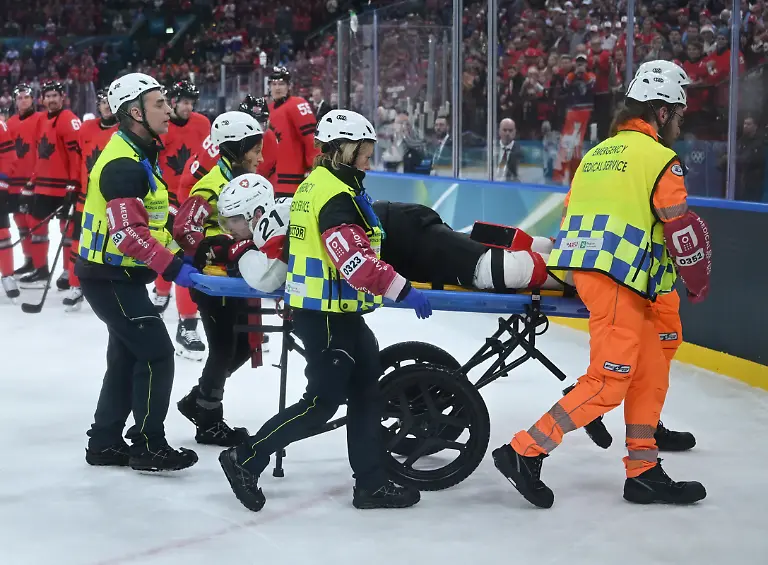 260214-MILAN-Feb-14-2026-Xinhua-Kevin-Fiala-of-Switzerland-is-strechered-off-by-medical-personnel-during-the-ice-hockey-men-s-preliminary-round-group-A-match-between-Canada-and-Switzerland-at-the-Milan-Cortina-2026-Olympic-Winter-Games-in-Milan-Italy-Feb-13-2026