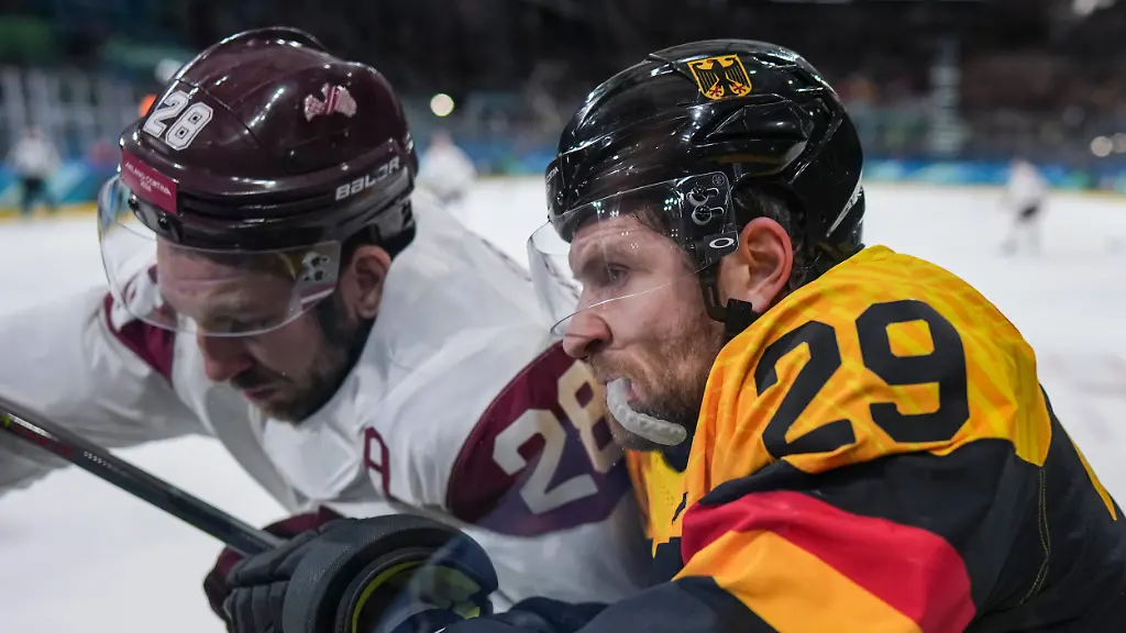 260214-MILAN-Feb-14-2026-Zegmus-Girgensons-L-of-Latvia-and-Leon-Draisaitl-of-Germany-battle-for-the-puck-during-the-Ice-hockey-Eishockey-men-s-preliminary-round-group-C-match-between-Germany-and-Latvia-of-the-Milan-Cortina-2026-Olympic-Winter-games-Winterspiele-Spiele-Summer-games-in-Milan-Italy-Feb-14-2026