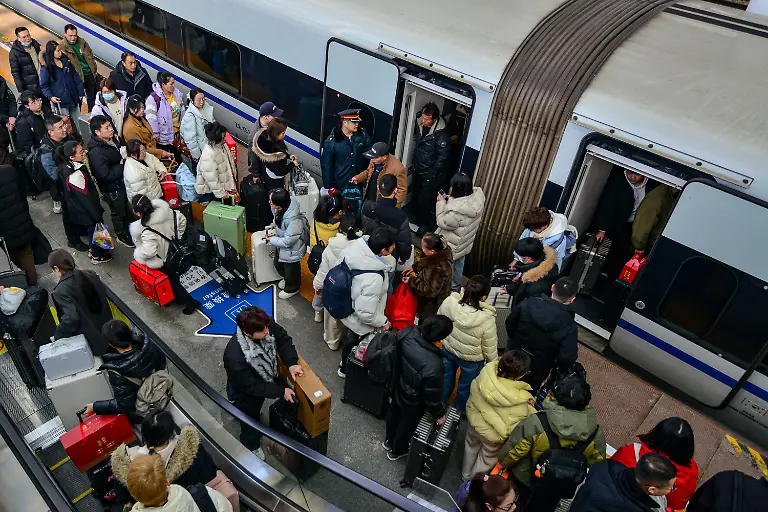 Passengers-board-a-high-speed-train-at-Fuyang-West-Railway-Station-Spring-Festival-Travel-Rush-Chunyun-is-the-worlds-largest-annual-human-migration-It-lasts-about-40-days-15-days-before-the-Lunar-New-Year-and-25-days-after-during-which-hundreds-of-millions-of-people-travel-home-for-family-reunions-or-go-on-trips