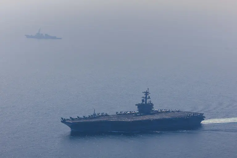 ARABIAN-SEA-FEBRUARY-6-EDITORIAL-USE-ONLY-MANDATORY-CREDIT-U-S-CENTRAL-COMMAND-HANDOUT-NO-MARKETING-NO-ADVERTISING-CAMPAIGNS-DISTRIBUTED-AS-A-SERVICE-TO-CLIENTS-An-aerial-view-of-the-USS-Abraham-Lincoln-Carrier-Strike-Group-while-operating-at-the-Arabian-Sea-escorted-by-two-military-replenishment-ships-and-two-U-S-Coast-Guard-vessels-as-fighter-jets-from-Carrier-Air-Wing-Nine-conducted-flight-operations-overhead-in-the-Arabian-Sea-on-February-6-2026