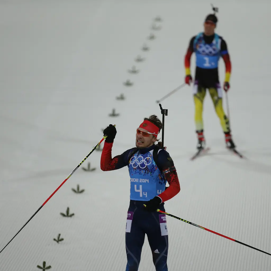 Simon-Schempp-back-of-Germany-and-Anton-Schipulin-of-Russia-in-the-finish-area-of-the-Biathlon-Men-s-4x7-5km-Relay-in-Laura-Cross-country-Ski-Biathlon-Center-at-the-Sochi-2014-Olympic-Games-Krasnaya-Polyana-Russia-22-February-2014