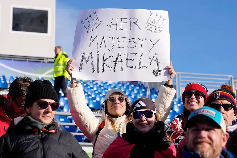 Olympics-Alpine-Skiing-Womens-Slalom-Feb-18-2026-Cortina-d-Ampezzo-Italy-United-States-fans-show-their-support-for-gold-medalist-Mikaela-Shiffrin-of-the-United-States-celebrates-after-the-women-s-slalom-during-the-Milano-Cortina-2026-Olympic-Winter-games-Winterspiele-Spiele-Summer-games-at-Tofane-Alpine-Skiing-Centre