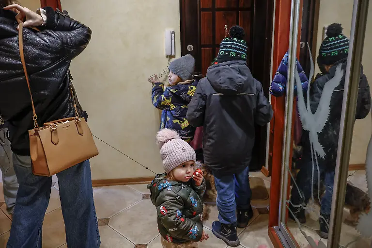 The-Davydenko-family-prepares-to-leave-their-family-apartment-and-head-to-their-cafe-where-they-are-staying-because-their-apartment-has-no-heating-or-hot-water-and-faces-frequent-power-outages-amid-Russia-s-attack-on-Ukraine-in-Kyiv-Ukraine-February-1-2026-Waves-of-Russian-attacks-over-the-past-four-months-left-hundreds-of-thousands-without-electricity-and-water-making-this-the-most-devastating-winter-since-the-war-started-and-so-the-Davydenko-family-made-the-choice-to-stay-at-the-family-owned-Piggy-Cafe-Kyiv-with-power-supplied-by-a-generator-and-heating-Maksym-likes-it-the-father-Denys-Davydenko-40-joked-about-their-new-reality-He-actually-says-that-at-home-we-have-to-do-household-chores-Now-there-s-no-dish-washing-cleaning-walking-the-dogs-So-he-is-happy-about-that-REUTERS-Alina-Smutko-SEARCH-SMUTKO-COLD-FAMILY-FOR-THIS-STORY-SEARCH-WIDER-IMAGE-FOR-ALL-STORIES