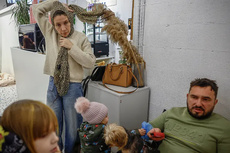 Yuliia-Davydenko-40-her-husband-Denys-40-and-their-children-arrive-to-the-family-s-cafe-where-they-are-staying-because-their-apartment-has-no-heating-or-hot-water-and-faces-frequent-power-outages-amid-Russia-s-attack-on-Ukraine-in-Kyiv-Ukraine-February-1-2026-Waves-of-Russian-attacks-over-the-past-four-months-left-hundreds-of-thousands-without-electricity-and-water-making-this-the-most-devastating-winter-since-the-war-started-and-so-the-Davydenko-family-made-the-choice-to-stay-at-the-family-owned-Piggy-Cafe-Kyiv-with-power-supplied-by-a-generator-and-heating-Maksym-likes-it-Denys-joked-about-their-new-reality-He-actually-says-that-at-home-we-have-to-do-household-chores-Now-there-s-no-dish-washing-cleaning-walking-the-dogs-So-he-is-happy-about-that-REUTERS-Alina-Smutko-SEARCH-SMUTKO-COLD-FAMILY-FOR-THIS-STORY-SEARCH-WIDER-IMAGE-FOR-ALL-STORIES