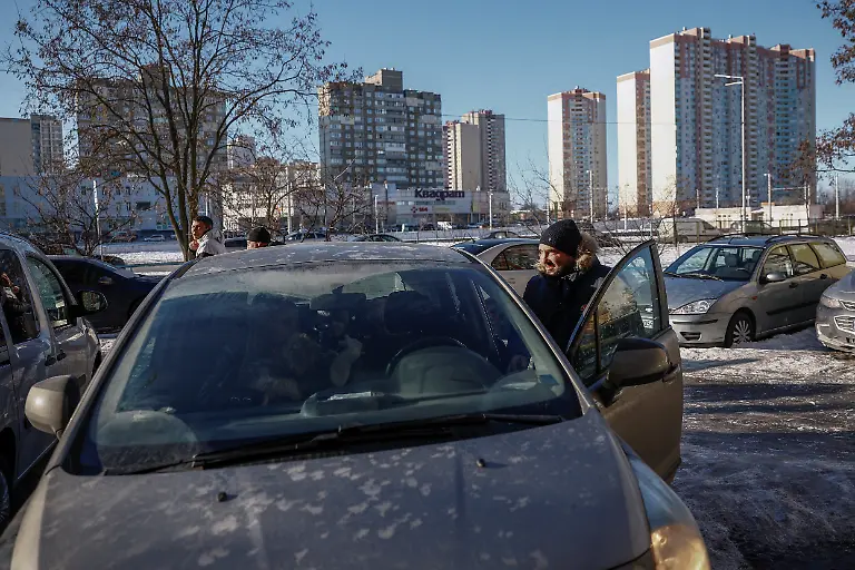 Denys-Davydenko-40-steps-inside-the-family-s-car-as-they-head-towards-the-family-s-cafe-where-they-are-staying-because-their-apartment-has-no-heating-or-hot-water-and-faces-frequent-power-outages-amid-Russia-s-attack-on-Ukraine-in-Kyiv-Ukraine-February-1-2026-Waves-of-Russian-attacks-over-the-past-four-months-left-hundreds-of-thousands-without-electricity-and-water-making-this-the-most-devastating-winter-since-the-war-started-and-so-the-Davydenko-family-made-the-choice-to-stay-at-the-family-owned-Piggy-Cafe-Kyiv-with-power-supplied-by-a-generator-and-heating-Maksym-likes-it-Denys-joked-about-their-new-reality-He-actually-says-that-at-home-we-have-to-do-household-chores-Now-there-s-no-dish-washing-cleaning-walking-the-dogs-So-he-is-happy-about-that-REUTERS-Alina-Smutko-SEARCH-SMUTKO-COLD-FAMILY-FOR-THIS-STORY-SEARCH-WIDER-IMAGE-FOR-ALL-STORIES