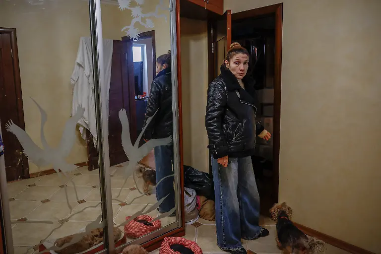 Yuliia-Davydenko-40-stands-in-winter-clothes-in-the-hallway-of-her-family-s-apartment-which-has-no-heating-or-hot-water-and-experiences-frequent-power-outages-amid-Russia-s-attack-on-Ukraine-in-Kyiv-Ukraine-February-1-2026-Waves-of-Russian-attacks-over-the-past-four-months-left-hundreds-of-thousands-without-electricity-and-water-making-this-the-most-devastating-winter-since-the-war-started-for-the-city-s-three-million-people-and-so-the-Davydenko-family-made-the-choice-to-stay-at-the-family-owned-Piggy-Cafe-Kyiv-with-power-supplied-by-a-generator-and-heating-The-point-when-we-decide-to-leave-Kyiv-again-would-be-when-Russian-troops-are-10-12-km-from-the-city-That-s-it-Yuliia-said-REUTERS-Alina-Smutko-SEARCH-SMUTKO-COLD-FAMILY-FOR-THIS-STORY-SEARCH-WIDER-IMAGE-FOR-ALL-STORIES