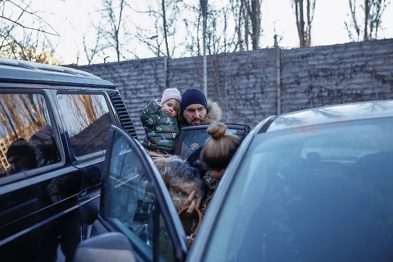 Denys-Davydenko-40-helps-his-children-get-out-of-the-family-car-before-heading-inside-the-family-s-cafe-where-they-are-staying-because-their-apartment-has-no-heating-or-hot-water-and-faces-frequent-power-outages-amid-Russia-s-attack-on-Ukraine-amid-Russia-s-attack-on-Ukraine-in-Kyiv-Ukraine-February-1-2026-Waves-of-Russian-attacks-over-the-past-four-months-left-hundreds-of-thousands-without-electricity-and-water-making-this-the-most-devastating-winter-since-the-war-started-and-so-the-Davydenko-family-made-the-choice-to-stay-at-the-family-owned-Piggy-Cafe-Kyiv-with-power-supplied-by-a-generator-and-heating-Maksym-likes-it-Denys-joked-about-their-new-reality-He-actually-says-that-at-home-we-have-to-do-household-chores-Now-there-s-no-dish-washing-cleaning-walking-the-dogs-So-he-is-happy-about-that-REUTERS-Alina-Smutko-SEARCH-SMUTKO-COLD-FAMILY-FOR-THIS-STORY-SEARCH-WIDER-IMAGE-FOR-ALL-STORIES
