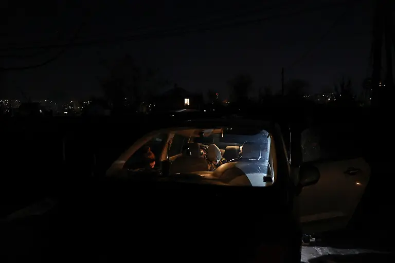 The-Davydenko-family-exit-their-car-before-entering-the-public-bathhouse-as-their-apartment-has-no-heating-or-hot-water-and-faces-frequent-power-outages-amid-Russia-s-attack-on-Ukraine-in-Kyiv-Ukraine-February-3-2026-Waves-of-Russian-attacks-over-the-past-four-months-left-hundreds-of-thousands-without-electricity-and-water-making-this-the-most-devastating-winter-since-the-war-started-and-so-the-Davydenko-family-made-the-choice-to-stay-at-the-family-owned-Piggy-Cafe-Kyiv-with-power-supplied-by-a-generator-and-heating-Maksym-likes-it-the-father-Denys-Davydenko-40-joked-about-their-new-reality-He-actually-says-that-at-home-we-have-to-do-household-chores-Now-there-s-no-dish-washing-cleaning-walking-the-dogs-So-he-is-happy-about-that-REUTERS-Alina-Smutko-SEARCH-SMUTKO-COLD-FAMILY-FOR-THIS-STORY-SEARCH-WIDER-IMAGE-FOR-ALL-STORIES