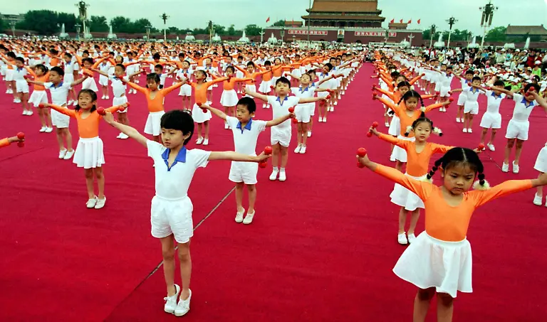 School-children-perform-gymnastics-with-Beijing-s-Gate-of-Heavenly-Peace-as-a-backdrop-during-a-rally-in-Tiananmen-Square-May-31-The-rally-attended-by-nearly-2-000-school-children-from-Hong-Kong-and-mainland-Chinese-provinces-was-held-to-welcome-the-15th-session-of-the-Chinese-Communist-Party-with-31-days-remaining-until-Hong-Kong-reverts-to-Chinese-rule-at-midnight-on-July-1-The-national-capital-is-stepping-up-performances-and-gala-events-to-mark-the-end-of-156-years-of-British-rule-in-the-territory