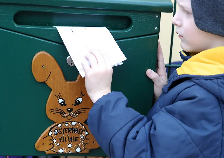 Einen-Brief-an-den-Osterhasen-steckt-der-sechsjaehrige-Toni-am-05-03-2014-in-einen-Briefkasten-in-Osterhausen-Sachsen-Anhalt-Der-Briefkasten-befindet-sich-an-einem-Kindergarten-in-dem-Ort-So-koennen-Kinder-dem-Osterhasen-ihre-Wuensche-verraten