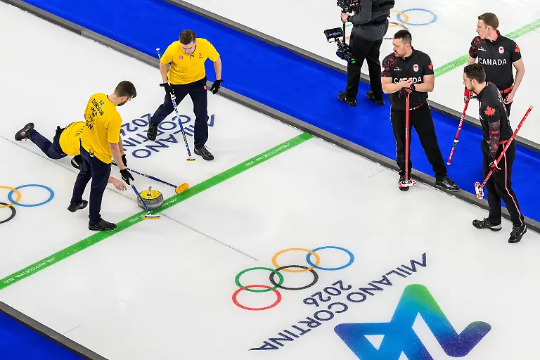 260213-Oskar-Eriksson-Rasmus-Wrana-and-Christoffer-Sundgren-of-Sweden-and-Ben-Hebert-Brett-Gallant-and-Marc-Kennedy-of-Canada-compete-in-a-men-s-round-robin-curling-match-between-Canada-and-Sweden-during-day-7-of-the-2026-Winter-Olympics-on-February-13-2026-in-Cortina