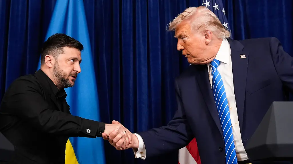 FILE-President-Donald-Trump-right-and-Ukraine-s-President-Volodymyr-Zelenskyy-shake-hands-at-the-start-of-a-joint-news-conference-following-a-meeting-at-Trump-s-Mar-a-Lago-club-Dec-28-2025-in-Palm-Beach-Fla