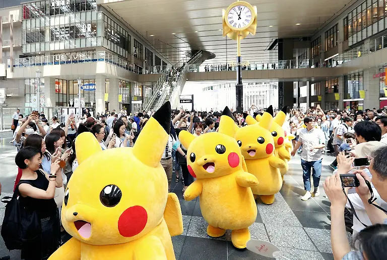 FILE-This-photo-taken-on-July-16-2016-shows-many-persons-in-costumes-of-Pikachu-one-of-the-main-characters-in-the-popular-game-Pocket-Monster-better-known-as-Pokemon-appeals-in-front-of-JR-Osaka-Station-Osaka-Prefecture-on-July-16-2016-Creators-of-the-game-at-the-time-of-its-1996-debut-told-the-design-for-Pikachu-was-based-on-a-squirrel-and-not-a-mouse-to-the-Yomiuri-Shimbun-during-an-interview-on-April-25-2018