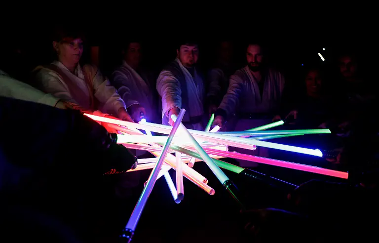 Golden-Gate-Knights-students-and-instructors-join-light-sabers-after-meditating-in-class-in-San-Francisco-Sunday-Feb-10-2013-A-group-of-San-Francisco-Star-Wars-fans-who-want-to-travel-to-a-galaxy-not-that-far-away-have-created-a-combat-choreography-class-for-Jedis-in-training-with-their-weapon-of-choice-the-light-saber