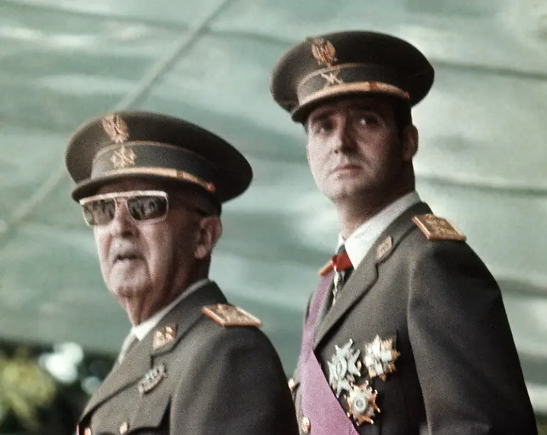 FILE-This-is-a-May-1973-file-photo-of-Spain-s-leader-Francisco-Franco-left-with-his-future-successor-as-King-Prince-Juan-Carlos-de-Borbon-as-they-watch-a-military-parade-in-Madrid-Spain-s-King-Juan-Carlos-will-abdicate-and-pave-the-way-for-his-son-Crown-Prince-Felipe-to-take-over-Spanish-Prime-Minister-Mariano-Rajoy-told-the-country-Monday-in-an-announcement-broadcast-nationwide-He-did-not-say-when-Juan-Carlos-would-abdicate-because-the-government-must-now-craft-a-law-creating-a-legal-mechanism-for-the-abdication-and-for-46-year-old-Felipe-s-assumption-of-power-King-Juan-Carlos-came-to-power-in-1975-two-days-after-the-death-of-longtime-dictator-Francisco-Franco-He-endeared-himself-to-many-Spaniards-in-large-part-by-putting-down-an-attempted-military-coup-in-1981-when-he-was-a-young-and-largely-untested-head-of-state