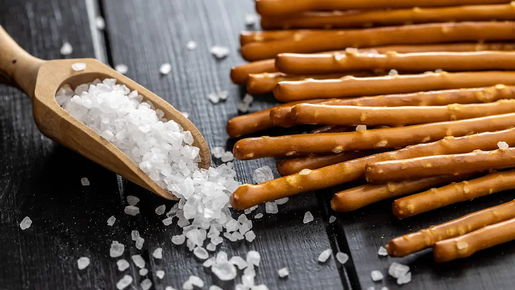 Salty-sticks-Crunchy-pretzels-and-coarse-salt-in-wooden-scoop-Salty-sticks-Crunchy-pretzels-and-coarse-salt-in-wooden-scoop-Copyright-xZoonar
