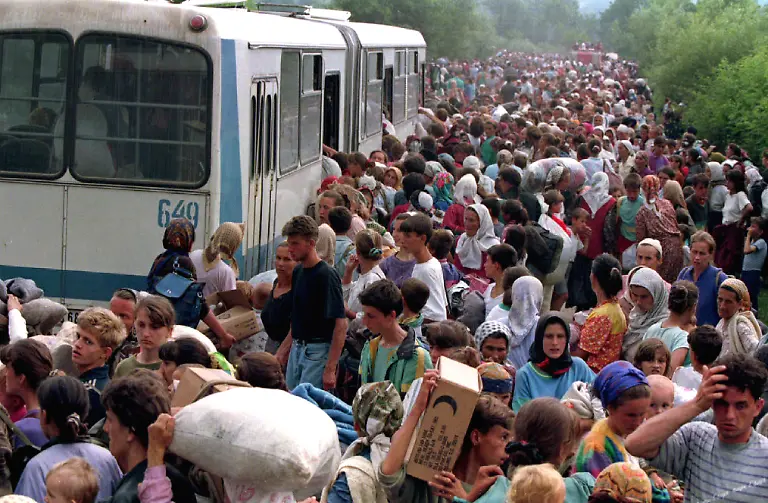 Around-10-000-refugees-from-Srebrenica-board-buses-at-a-camp-outside-the-UN-base-at-Tuzla-Airport-heading-for-other-refugee-camps-in-the-Tuzla-area-July-14