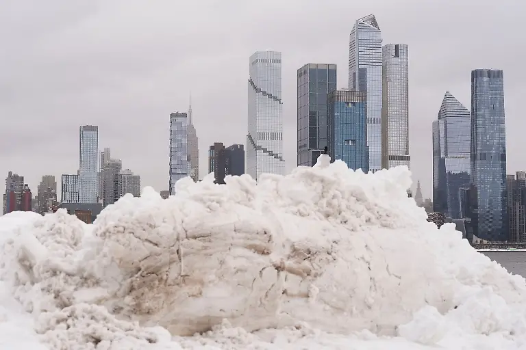 A-piece-of-the-New-York-skyline-rises-above-a-pile-of-snow-on-the-Weekhawken-N-J-waterfront-Monday-Feb-23-2026
