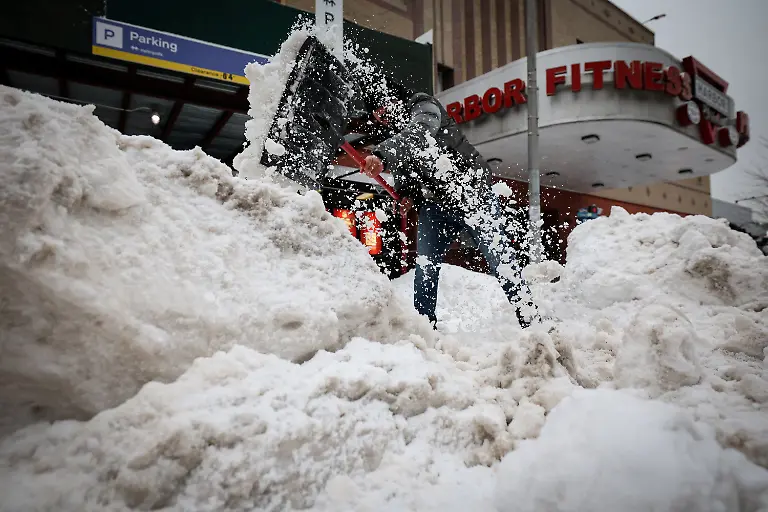 A-worker-clears-snow-from-the-entrance-to-a-parking-lot-as-a-major-winter-storm-spreads-across-a-large-swath-of-the-United-States-in-New-York-City-U-S-January-26-2026