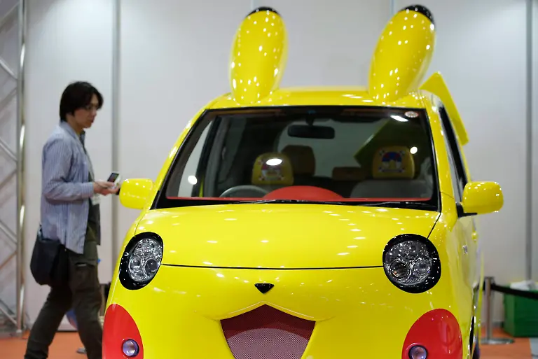 epa04251413-A-visitor-looks-at-a-Pokemon-series-character-Pikachu-designed-Toyota-Motor-Corp-Porte-vehicle-displayed-at-the-International-Tokyo-Toy-Show-2014-in-Tokyo-Japan-12-June-2014-The-trade-show-is-opened-for-business-visitors-on-12-and-13-June-while-it-opens-to-the-public-on-14-and-15-June