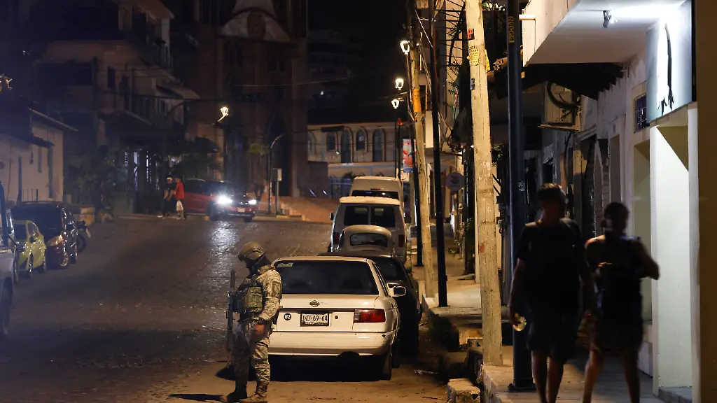 A-soldier-stands-guard-on-a-street-in-a-tourist-area-a-day-after-a-series-of-blockades-and-attacks-by-organized-crime-following-a-military-operation-in-which-cartel-boss-Nemesio-Oseguera-El-Mencho-was-killed-in-Jalisco-state-in-Puerto-Vallarta-Mexico-February-23-2026