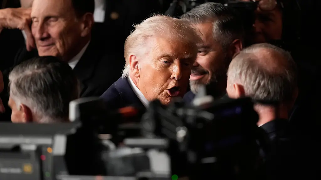 President-Donald-Trump-is-congratulated-as-he-leaves-the-House-chamber-following-his-State-of-the-Union-address-to-a-joint-session-of-Congress-at-the-U-S-Capitol-in-Washington-Tuesday-Feb-24-2026-Vice-President-JD-Vance-looks-on