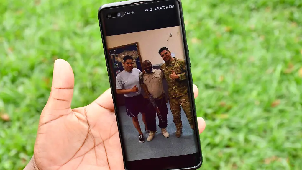 Caroline-Mukiza-wife-to-the-deceased-soldier-Mr-Edison-Kamwesigye-in-Russia-holds-a-portrait-of-the-late-husband-outside-St-Augustine-Chapel-at-Makerere-University-in-Kampala-Uganda-on-February-10-2026