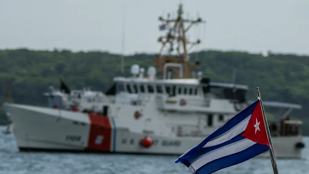 FILE-In-this-June-29-2021-file-photo-a-Cuban-flag-from-a-Cuban-Border-Patrol-boat-flies-as-the-Coast-Guard-Sentinel-class-cutter-Charles-Sexton-arrives-to-deliver-Cuban-deportees-to-the-authorities-at-Orozco-Bay-in-Artemisa-Cuba-Cuba-is-seeing-a-surge-in-unauthorized-migration-to-the-United-States-fueled-by-an-economic-crisis