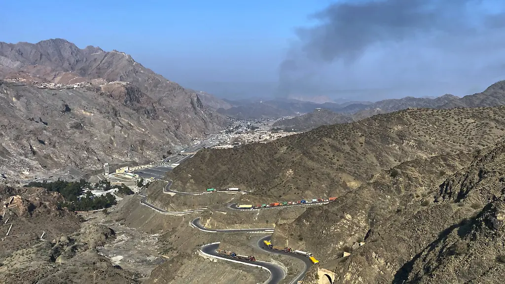 Smoke-emits-from-Afghan-side-as-trucks-are-parked-along-roadside-following-cross-border-clashes-between-Pakistan-and-Afghan-forces-at-near-Torkham-border-crossing-point-Pakistan-Saturday-Feb-28-2026
