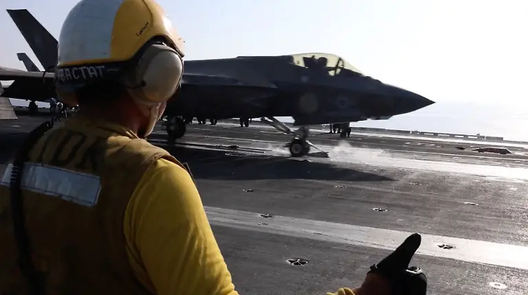 A-screengrab-from-a-video-released-by-U-S-Central-Command-CENTCOM-which-accompanied-a-press-release-describing-the-operation-dubbed-Epic-Fury-an-attack-by-the-United-States-and-Israel-on-Iran-shows-a-flight-deck-crew-member-signaling-an-F-35-jet-on-an-aircraft-carrier-in-this-image-obtained-from-social-media-released-on-February-28-2026-US-CENTCOM-via-X-via-REUTERS-THIS-IMAGE-HAS-BEEN-SUPPLIED-BY-A-THIRD-PARTY-Verification-lines-The-location-and-the-date-when-the-video-was-filmed-could-not-be-verified-U-S-confirmed-attack-on-Iran-on-Saturday-February-28
