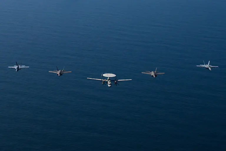 ARABIAN-SEA-FEBRUARY-6-EDITORIAL-USE-ONLY-MANDATORY-CREDIT-U-S-CENTRAL-COMMAND-HANDOUT-NO-MARKETING-NO-ADVERTISING-CAMPAIGNS-DISTRIBUTED-AS-A-SERVICE-TO-CLIENTS-An-aerial-view-of-the-USS-Abraham-Lincoln-Carrier-Strike-Group-while-operating-at-the-Arabian-Sea-escorted-by-two-military-replenishment-ships-and-two-U-S-Coast-Guard-vessels-as-fighter-jets-from-Carrier-Air-Wing-Nine-conducted-flight-operations-overhead-in-the-Arabian-Sea-on-February-6-2026