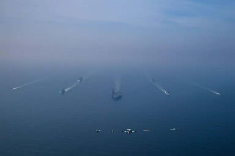ARABIAN-SEA-FEBRUARY-6-EDITORIAL-USE-ONLY-MANDATORY-CREDIT-U-S-CENTRAL-COMMAND-HANDOUT-NO-MARKETING-NO-ADVERTISING-CAMPAIGNS-DISTRIBUTED-AS-A-SERVICE-TO-CLIENTS-An-aerial-view-of-the-USS-Abraham-Lincoln-Carrier-Strike-Group-while-operating-at-the-Arabian-Sea-escorted-by-two-military-replenishment-ships-and-two-U-S-Coast-Guard-vessels-as-fighter-jets-from-Carrier-Air-Wing-Nine-conducted-flight-operations-overhead-in-the-Arabian-Sea-on-February-6-2026