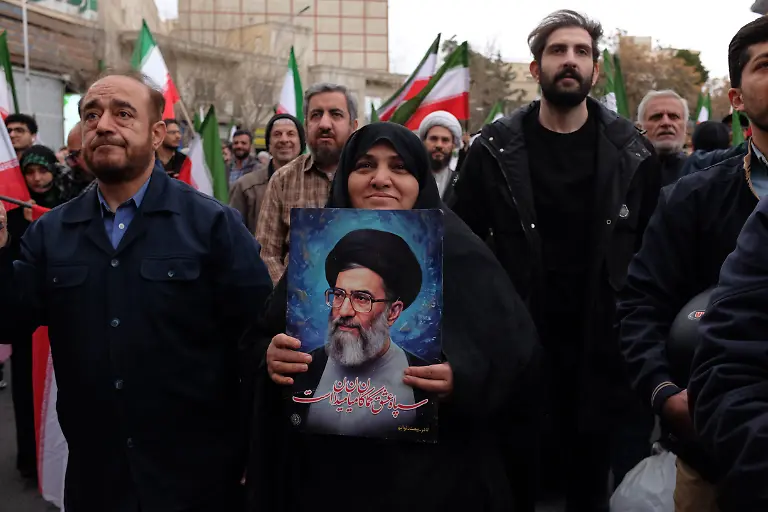 A-woman-holds-a-picture-of-the-Iranian-Supreme-Leader-Ayatollah-Ali-Khamenei-during-a-demonstration-in-support-of-the-government-and-against-U-S-and-Israeli-strikes-in-Tehran-Iran-Saturday-Feb-28-2026