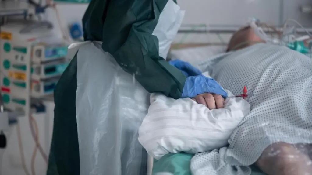 Eine-Mitarbeiterin-der-Pflege-in-Schutzausruestung-betreut-einen-Corona-Patienten