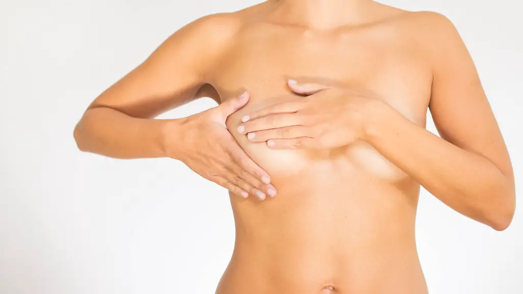 Woman-testing-her-breast-for-cancer-Close-up-view-of-the-naked-torso-of-a-woman-testing-her-breast-for-cancer-flattening-the-tissue-with-one-hand-and-manipulating-to-detect-lumps-with-the-fingers-on-her-other-hand-Copyright-xZoonar