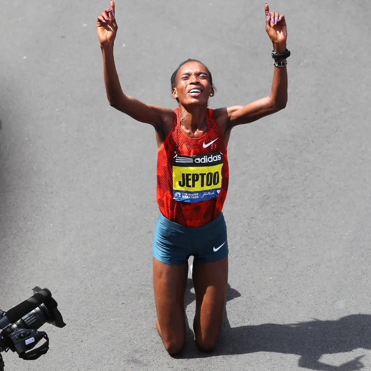 Women-s-elite-runner-Rita-Jeptoo-Sitienei-of-Kenya-falls-to-her-knees-after-winning-the-women-s-division-of-118th-Boston-Marathon-in-Boston-Massachusetts-on-April-21-2014