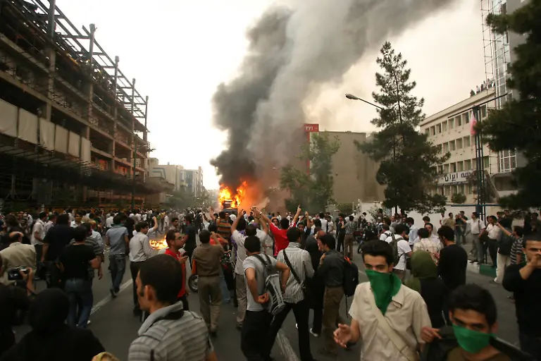 Supporters-of-defeated-Iranian-presidential-candidate-Mir-Hossein-Mousavi-burn-a-police-motorcylce-during-a-protest-in-Valiasr-Street-in-Tehran-Iran-on-June-13-2009-Hardline-incumbent-Mahmoud-Ahmadinejad-won-a-crushing-victory-in-Iran-s-hotly-disputed-presidential-vote-according-to-official-results-that-triggered-mass-opposition-protests-Photo-by-Golnaz-Beheshti-ParsPix-ABACAPRESS