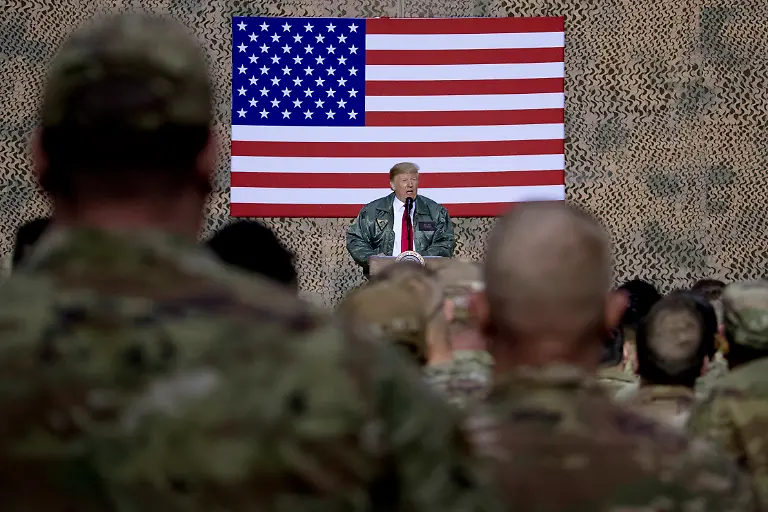 FILE-In-this-Dec-26-2018-file-photo-President-Donald-Trump-speaks-to-members-of-the-military-at-a-hangar-rally-at-Ain-al-Asad-air-base-Iraq-Iran-struck-back-at-the-United-States-for-the-killing-of-a-top-Iranian-general-early-Wednesday-Jan-8-2020-firing-a-series-of-ballistic-missiles-at-Iraqi-bases-housing-U-S-troops-in-a-major-escalation-of-tensions-that-brought-the-two-longtime-foes-closer-to-war