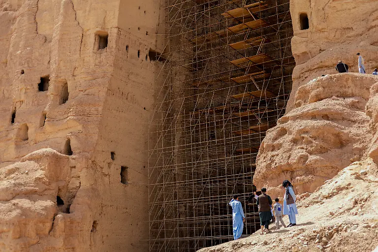 Visitors-gather-at-the-empty-niche-of-the-larger-Bamiyan-Buddha-in-Afghanistan-on-June-8-2025-once-home-to-a-55-meter-statue-carved-in-the-6th-century-and-destroyed-by-the-Taliban-in-2001