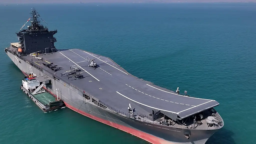 This-handout-photo-provided-by-Iran-s-Revolutionary-Guard-Corps-IRGC-official-website-Sepah-News-on-February-6-2025-reportedly-shows-the-first-Iranian-drone-carrier-called-the-Martyr-Bahman-Bagheri-during-an-unveiling-ceremony-in-the-Gulf-off-the-coast-of-southern-Iran-The-commercial-vessel-was-repurposed-as-a-drone-carrier-which-is-capable-of-launching-long-range-missiles-in-addition-to-carrying-drones-and-helicopters-over-the-past-two-and-a-half-years-according-to-Revolutionary-Guards-naval-commander-Alireza-Tangsiri-who-described-it-as-the-largest-naval-military-project-in-the-history-of-the-Islamic-republic