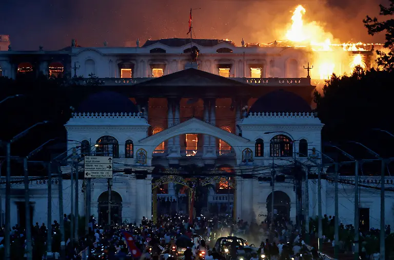Flames-rise-from-the-burning-Singha-Durbar-office-complex-which-houses-Nepal-s-prime-minister-s-office-and-other-ministries-during-a-curfew-imposed-after-youth-led-protests-that-toppled-Nepal-s-prime-minister-in-Kathmandu-Nepal-September-9-2025-77-people-were-killed-in-two-days-of-protests-that-later-forced-the-resignation-of-then-Prime-Minister-K-P-Sharma-Oli-and-shook-up-Nepal-s-broken-political-system-A-state-appointed-commission-charged-with-conducting-an-investigation-into-the-protests-including-the-use-of-live-ammunition-against-young-demonstrators-has-received-three-extensions-to-complete-the-probe-Its-final-findings-are-expected-to-be-released-after-the-general-election-set-for-March-5-2026-REUTERS-Navesh-Chitrakar-SEARCH-CHITRAKAR-NEPAL-PROTESTER-FAMILIES-FOR-THIS-STORY-SEARCH-WIDER-IMAGE-FOR-ALL-STORIES