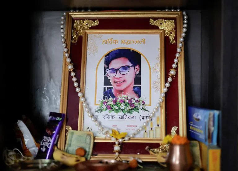 The-portrait-of-Rashik-Khatiwada-23-who-was-shot-dead-during-youth-led-protests-that-toppled-Nepal-s-prime-minister-and-prompted-elections-set-for-March-5-2026-is-seen-at-his-house-house-in-Kathmandu-Nepal-February-23-2026-After-years-of-being-largely-indifferent-to-politics-Khatiwada-joined-the-Rastriya-Swatantra-Party-stating-her-decision-was-driven-by-a-motivation-to-seek-justice-for-her-son-and-families-of-others-killed-in-the-protests-What-have-past-leaders-done-for-this-country-over-the-last-three-decades-They-accumulated-wealth-for-themselves-and-placed-their-own-people-in-positions-of-power-to-benefit-from-it-Rachana-Khatiwada-mother-of-Rashik-said-What-did-they-truly-do-for-the-nation-REUTERS-Navesh-Chitrakar-SEARCH-CHITRAKAR-NEPAL-PROTESTER-FAMILIES-FOR-THIS-STORY-SEARCH-WIDER-IMAGE-FOR-ALL-STORIES