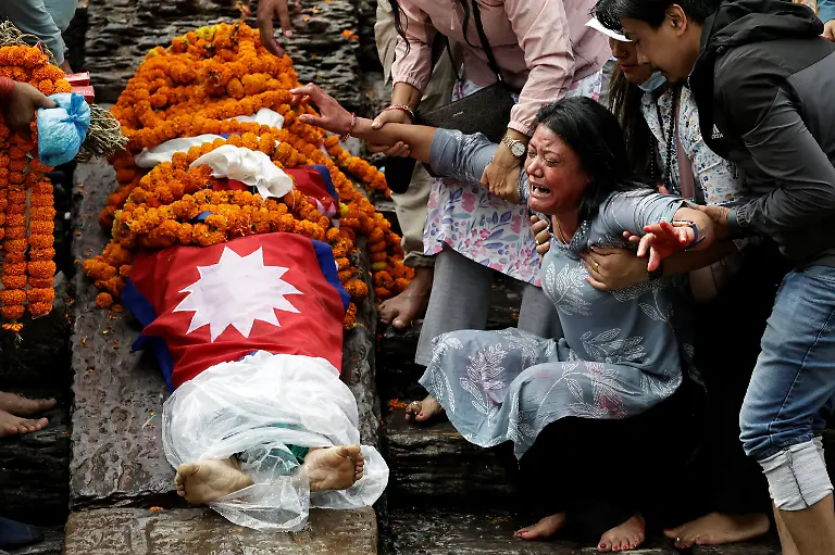 SENSITIVE-MATERIAL-THIS-IMAGE-MAY-OFFEND-OR-DISTURB-Rachana-Khatiwada-mother-of-Rashik-Khatiwada-23-who-was-shot-dead-during-youth-led-protests-that-toppled-Nepal-s-prime-minister-mourns-next-to-Rashik-s-body-during-cremation-rituals-on-the-premises-of-the-Pashupatinath-temple-along-the-bank-of-the-Bagmati-River-in-Kathmandu-Nepal-September-16-2025-After-years-of-being-largely-indifferent-to-politics-Khatiwada-joined-the-Rastriya-Swatantra-Party-stating-her-decision-was-driven-by-a-motivation-to-seek-justice-for-her-son-and-families-of-others-killed-in-the-protests-What-have-past-leaders-done-for-this-country-over-the-last-three-decades-They-accumulated-wealth-for-themselves-and-placed-their-own-people-in-positions-of-power-to-benefit-from-it-Khatiwada-said-What-did-they-truly-do-for-the-nation-REUTERS-Navesh-Chitrakar-SEARCH-CHITRAKAR-NEPAL-PROTESTER-FAMILIES-FOR-THIS-STORY-SEARCH-WIDER-IMAGE-FOR-ALL-STORIES