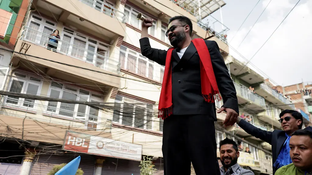 Balendra-Shah-a-rapper-turned-politician-and-the-prime-ministerial-candidate-for-the-Rastriya-Swatantra-Party-RSP-rings-a-bell-which-is-the-party-s-symbol-as-he-takes-part-in-an-election-campaign-in-Kirtipur-Kathmandu-Nepal-February-28-2026
