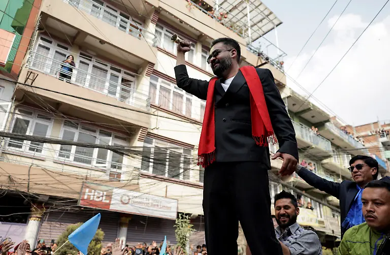 Balendra-Shah-a-rapper-turned-politician-and-the-prime-ministerial-candidate-for-the-Rastriya-Swatantra-Party-RSP-rings-a-bell-which-is-the-party-s-symbol-as-he-takes-part-in-an-election-campaign-in-Kirtipur-Kathmandu-Nepal-February-28-2026