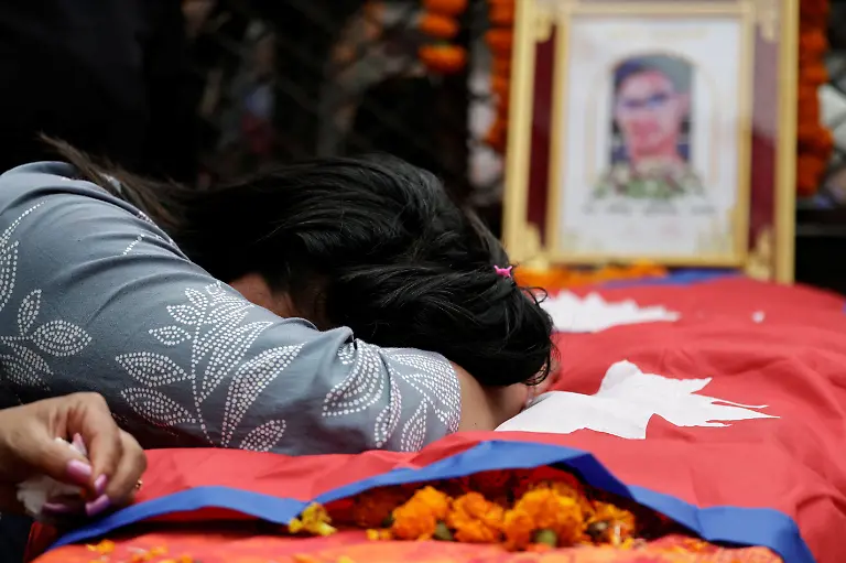 Rachana-Khatiwada-mother-of-Rashik-Khatiwada-23-who-was-shot-dead-during-youth-led-protests-that-toppled-Nepal-s-prime-minister-mourns-as-she-leans-on-the-coffin-containing-her-son-s-body-during-a-tribute-rally-in-Kathmandu-Nepal-September-16-2025-After-years-of-being-largely-indifferent-to-politics-Khatiwada-joined-the-Rastriya-Swatantra-Party-stating-her-decision-was-driven-by-a-motivation-to-seek-justice-for-her-son-and-the-families-of-others-killed-in-the-protests-What-have-past-leaders-done-for-this-country-over-the-last-three-decades-They-accumulated-wealth-for-themselves-and-placed-their-own-people-in-positions-of-power-to-benefit-from-it-she-said-What-did-they-truly-do-for-the-nation-REUTERS-Navesh-Chitrakar-SEARCH-CHITRAKAR-NEPAL-PROTESTER-FAMILIES-FOR-THIS-STORY-SEARCH-WIDER-IMAGE-FOR-ALL-STORIES